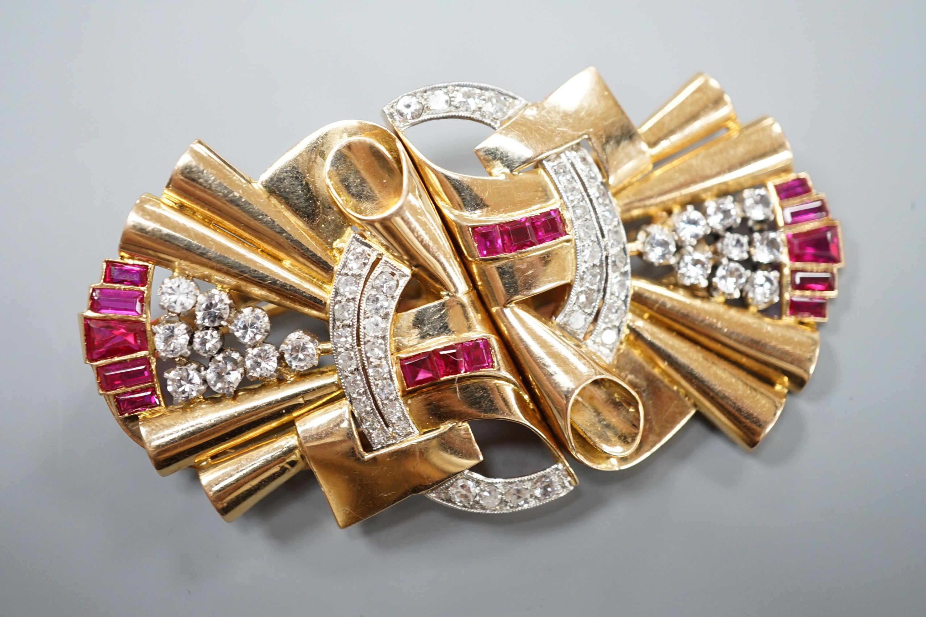 A 1950's yellow metal, white stone, diamond and synthetic? ruby set fan shaped double clip brooch, overall 66mm, gross 39.4 grams